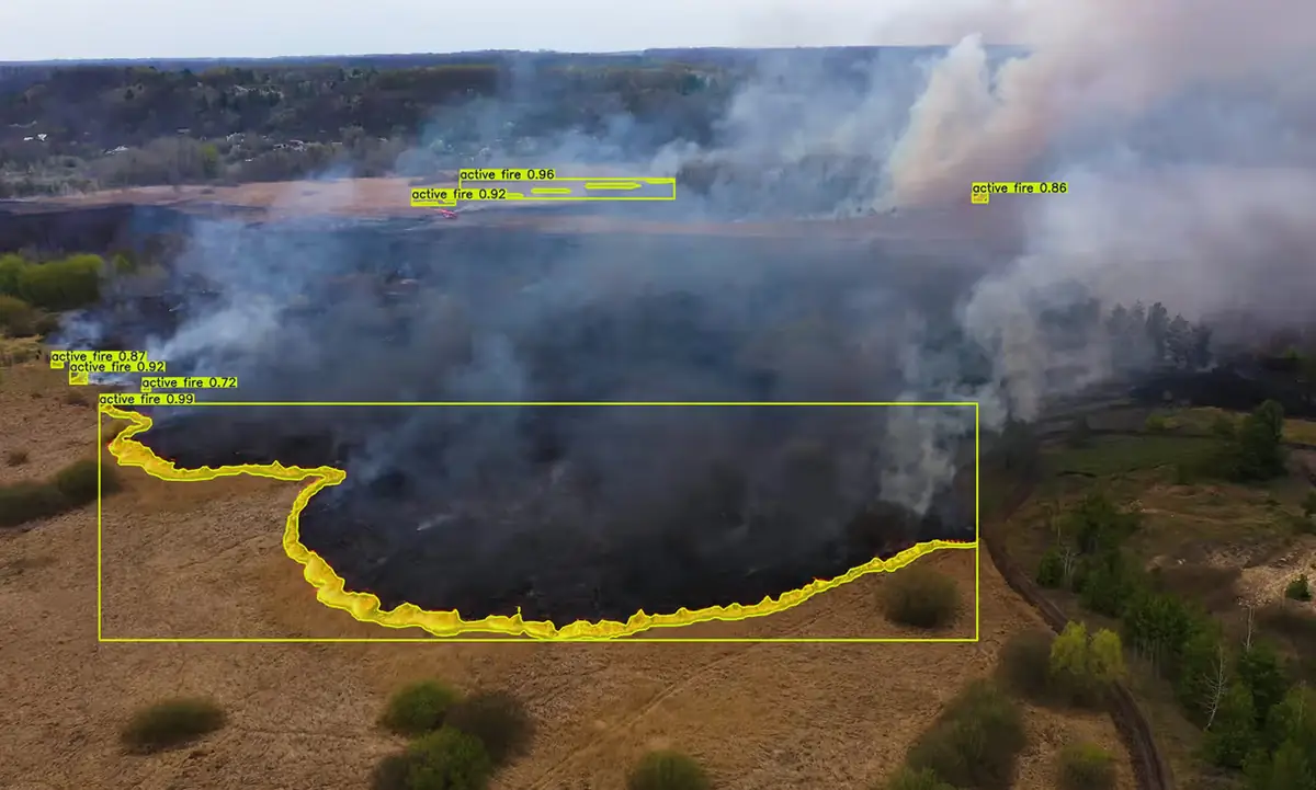 Aerial view of a bush fire with the burning edge and smoke outlined